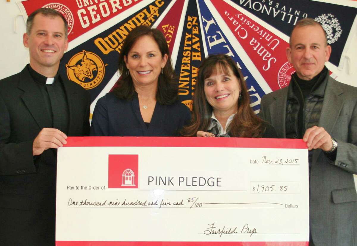 With a "big check" representing more than $1,900 raised by the Fairfield Prep community support of this year's Pink Pledge campaign are, from left, the Rev. Tom Simisky, S.J., the Prep president; guidance counselor Suzanne Gorab, Norma Pfriem Breats Care Center community education coordinator Nancy Church, and Prep Principal Robert Perrotta.