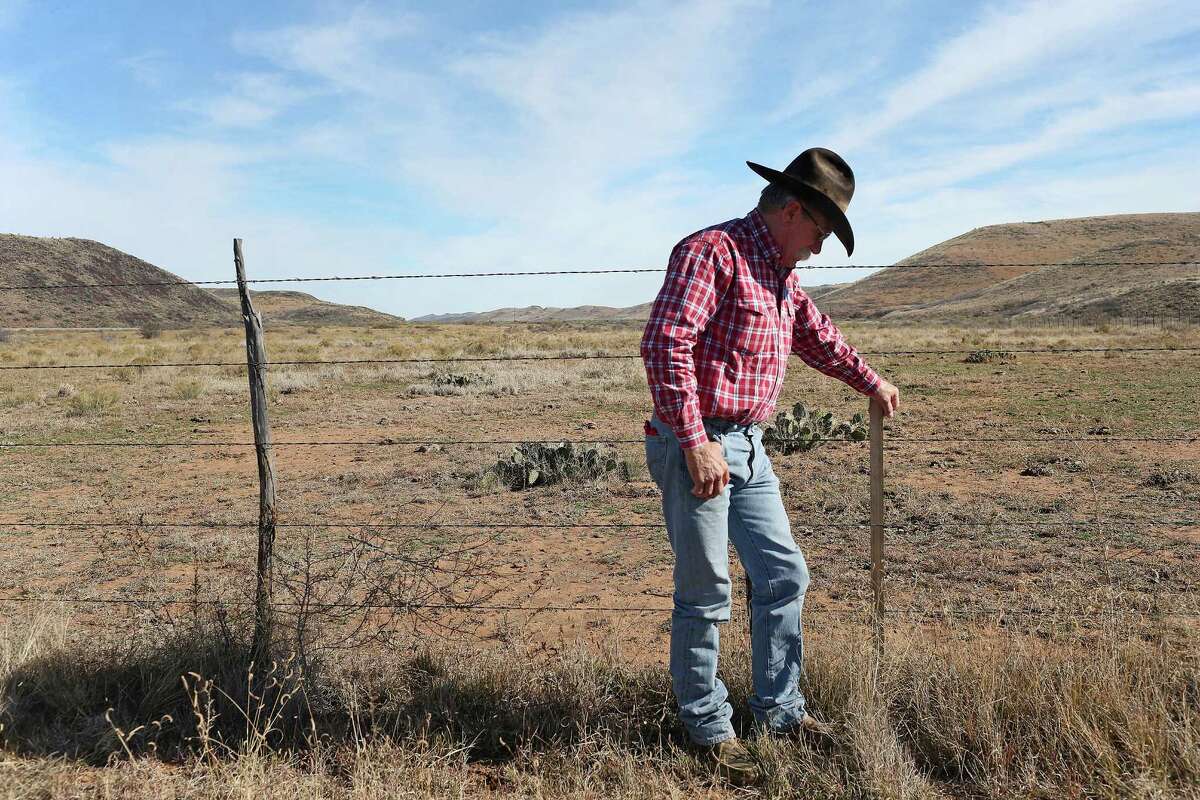 While working cattle, Joel Nelson checks out a marker for the Trans-Pecos Pipeline, Project that runs one-mile through the north part of his ranch near Alpine, Texas, Wednesday, Dec. 9, 2015. The Trans-Pecos Pipeline Project plans on running the pipe through a mile of Nelson's land. The pipeline will transport natural gas from a collection site west of Fort Stockton crossing the Big Bend area of Texas into Mexico upriver from Presidio. The pipeline is expected to cut through the middle of the valley behind him. ÒIÕve told a lot of people that my opposition to the pipeline is in now way based on my one-mile stretch of land. I could live with that,Ó he said. ÒItÕs the fact that it will go through some of the most beautiful open range country in Brewster and Presidio Counties, and it will disrupt and affect so many people. ItÕs a scene I canÕt stand,Ó he said.