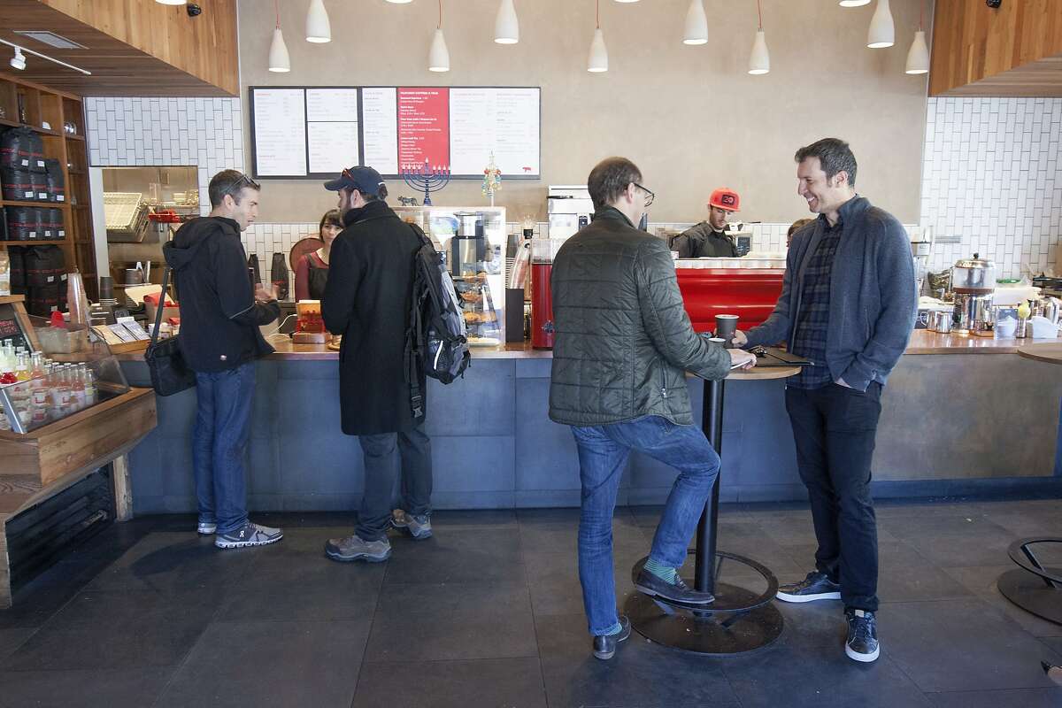Customers line up to buy coffee at Equator Coffee, Monday, Dec. 14, 2015, in Mill Valley, Calif.