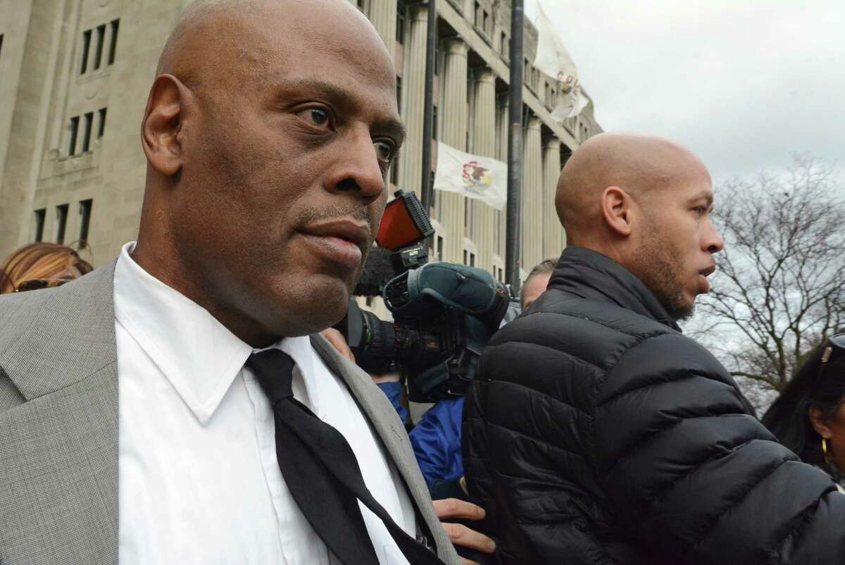 Chicago Police Cmdr. Glenn Evans, left,who was accused of shoving his gun down a suspect's throat and pressing a stun gun to the man's groin in 2013, leaves the Criminal Courts Building in Chicago on Monday, Dec. 14, 2015, after being acquitted on battery and misconduct charges. (Brian Jackson/Chicago Sun-Times via AP) CHICAGO TRIBUNE OUT, MANDATORY CREDIT, MAGS OUT, NO SALES