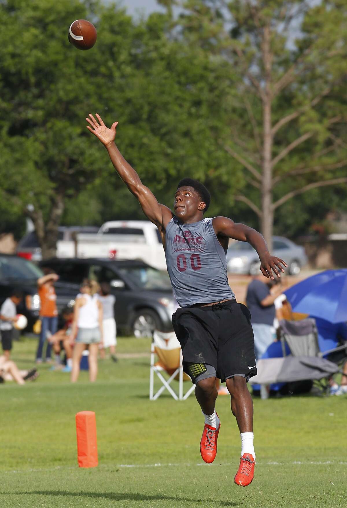 Fred Cooper of Reagan attempts a difficult catch in the third round of the Cinco Ranch Adrenaline 7-on-7 Tournament held at Cinco Ranch High School on June 27, 2014.