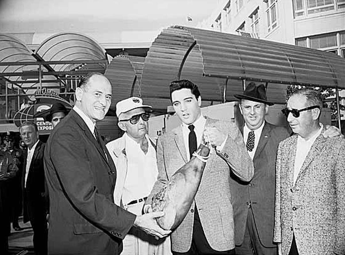 A Federal Way man who led what his attorney described as a ring of ‘pathetic crowd of fellow addicts’ in id theft spree against dozens of people says it all came apart for him when his wife ran off with an Elvis impersonator. The actual  Elvis Presley is pictured above presenting a ham to Washington Governor Al Rosellini at Seattle's Westlake Avenue Monorail station in 1962.