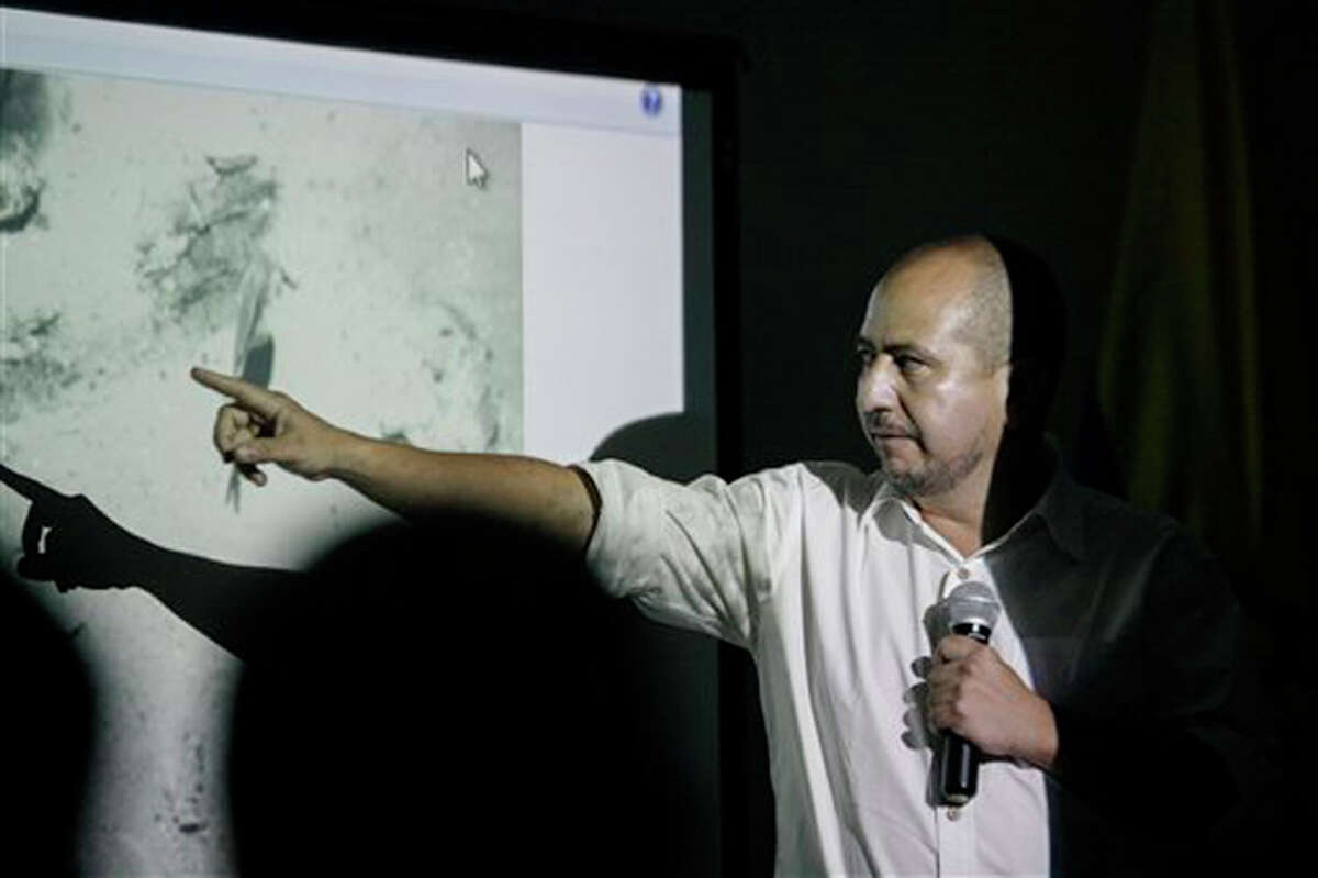 Ernesto Montenegro, Director of the Colombian Institute of Anthropology and History of Colombia, talks to the media while he shows a picture of remains of the Galleon San Jose during a press conference in Cartagena, Colombia, Saturday, Dec.5, 2015.