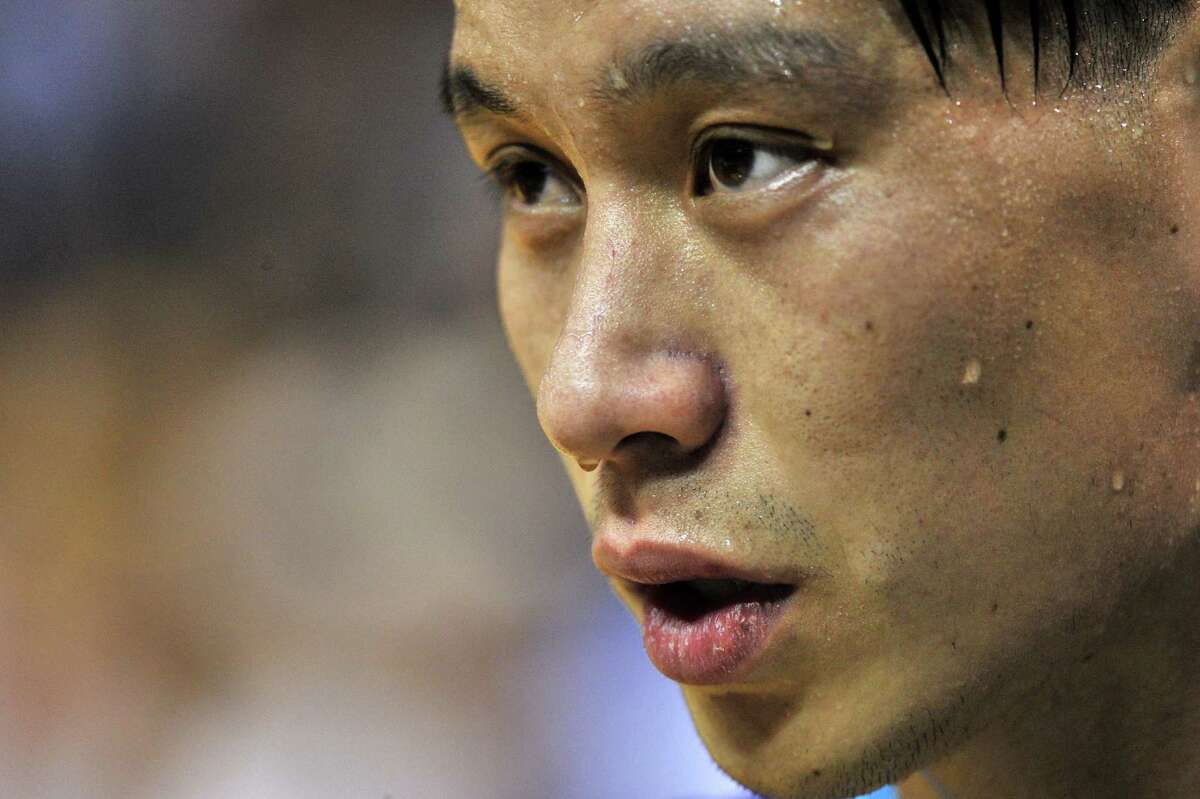 Charlotte Hornets guard Jeremy Lin talks with a reporter during half time of an NBA basketball game Friday, Dec. 11, 2015, in Memphis, Tenn. (AP Photo/Brandon Dill)