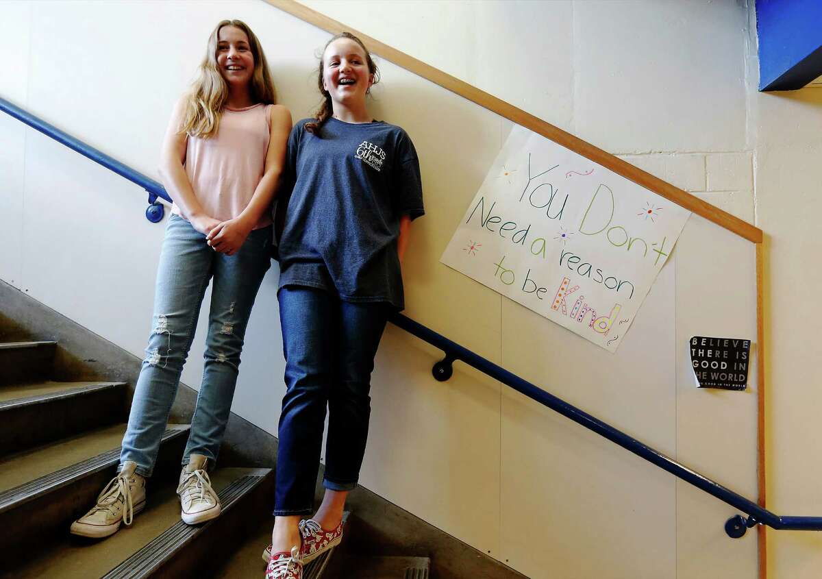 Alamo Heights Junior School sixth-graders Claire Dickey (left) and Liv Humphries joined schoolmates in posting messages of support and inspiration during a “kindess campaign.”