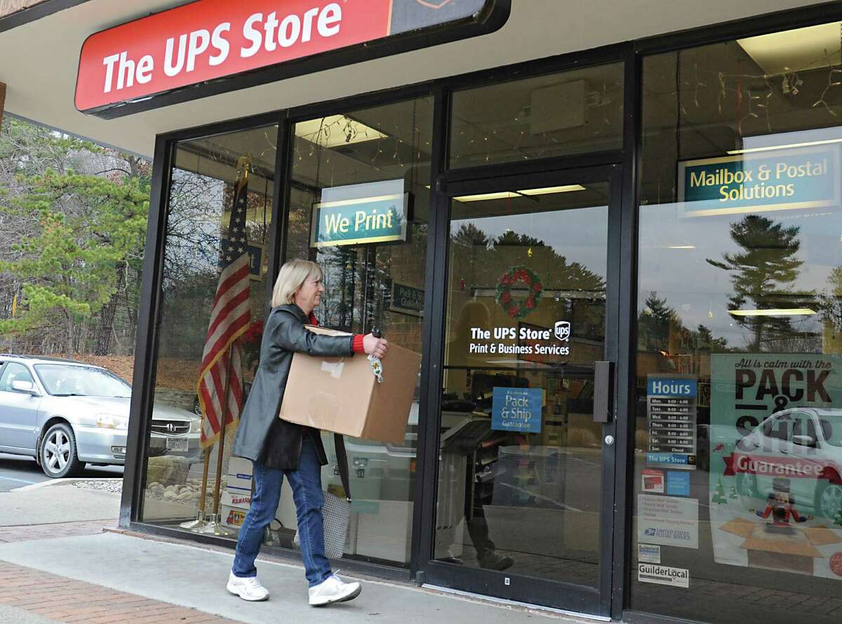 Barbara Pierce of Guilderland carries a package into The UPS Store on Wednesday, Dec. 16, 2015 in Guilderland, N.Y. (Lori Van Buren / Times Union)