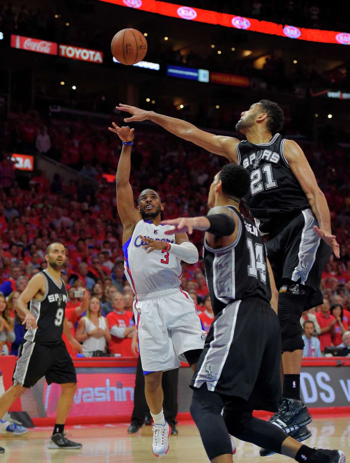 Clippers guard Chris Paul shoots over Spurs forward Tim Duncan (21) during the final seconds of Game 7 in a Western Conference first-round playoff series on May 2, 2015, in Los Angeles.