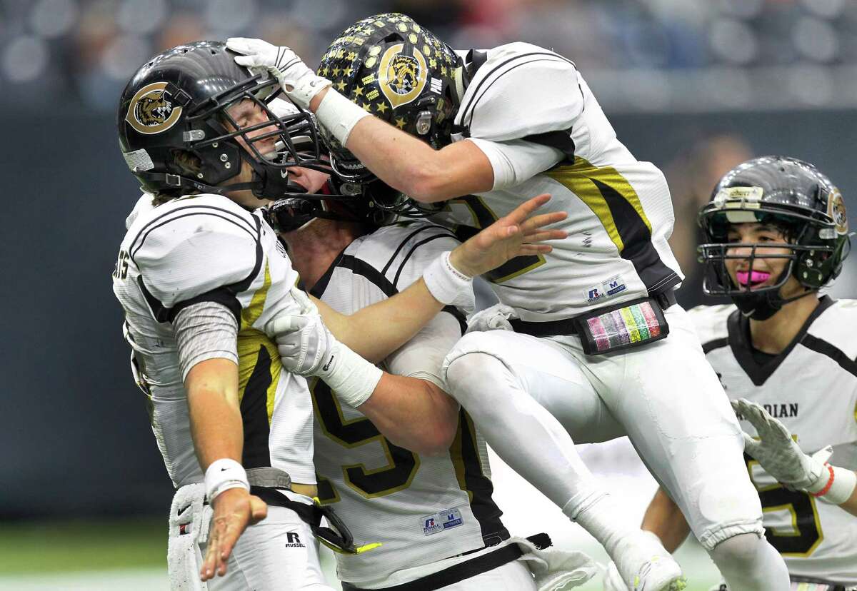 Canadian #9 Tanner Schafer is congratulated by teammates (left-right) #19 Sawyer Cook, #2 Cameron Copley and #5 Manny Ramsey after scoring a 2nd Quarter touchdown Thursday, Dec. 17, 2015, in Houston. Canadian defeated Refugio at NRG Stadium in the 2015 Texas High School Football Class 2A Division I Championship Game.
