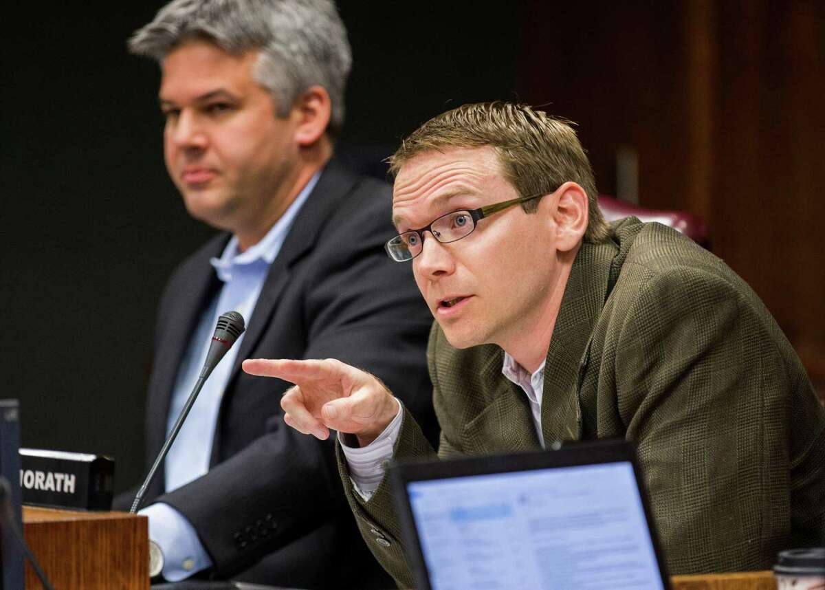 DISD Trustee District 2 Mike Morath, right, asks a question to attorneys before the DISD board of trustees meets in closed session on Monday, February 16, 2015 at DISD Headquarters in Dallas, Texas. At left is DISD Trustee District 7 Eric Cowan. (Ashley Landis/The Dallas Morning News)