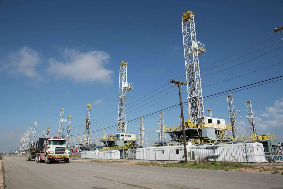 Drilling rigs standing idle in Odessa are testament to the drop in U.S. oil activity, but investment bank Goldman Sachs says oil prices will have to drop further to slow production enough to relieve the worldwide oil glut. ( AP photo)