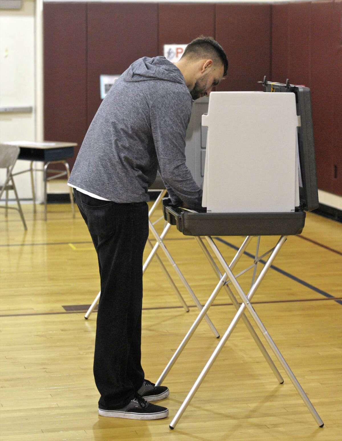 Matt Barnes, of Bethel, votes at the Berry School polling site on the referendum for the new police station in Bethel. Voters went to the polls to decide on the $13.5 million plan for a new police station. Thursday, December 17, 2015, in Bethel, Conn.