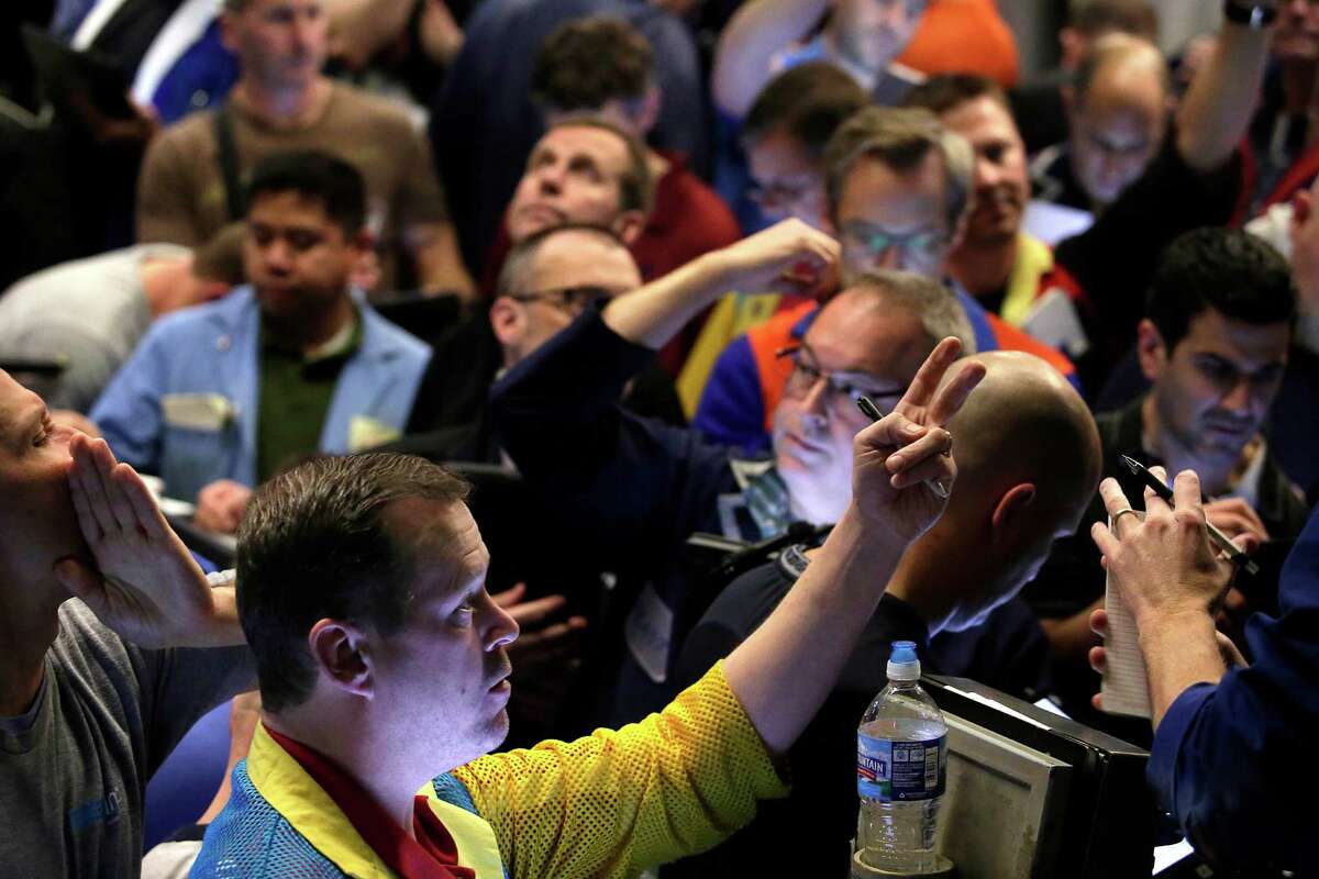 Traders in the Standard & Poor's 500 stock index options pit at the Chicago Board Options Exchange react to the Federal Reserve's interest rate decision this past week.