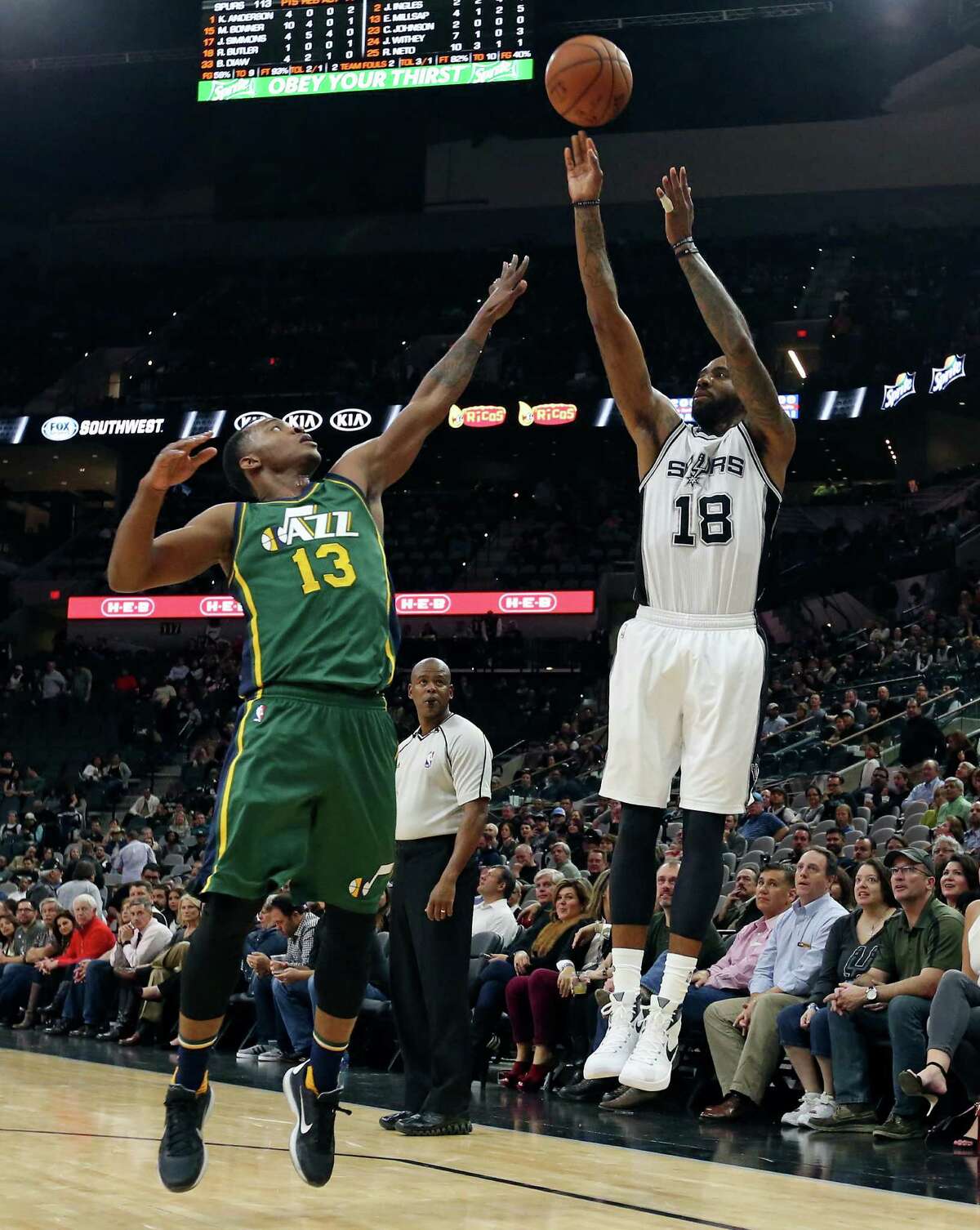 San Antonio Spurs' Rasual Butler shoots over Utah Jazz's Elijah Millsap during second half action Monday Dec. 14, 2015 at the AT&T Center. The Spurs won 118-81.