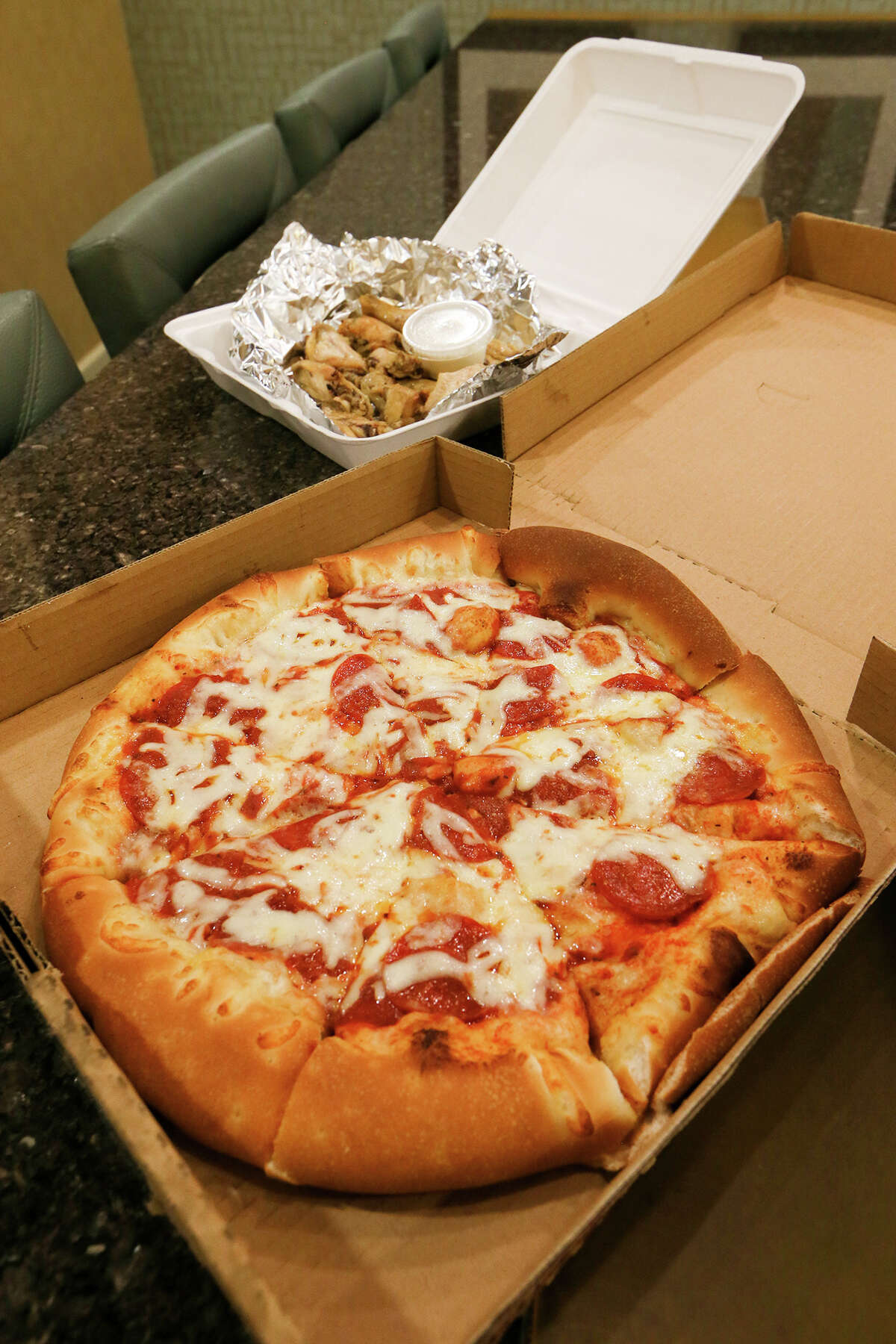Pepperoni pizza and an order of chicken wings from Chicago Pizzaria, 1704 N. PanAm Expy, delivered to reporter Richard Webner on Friday, Dec. 11, 2015. MARVIN PFEIFFER/ mpfeiffer@express-new