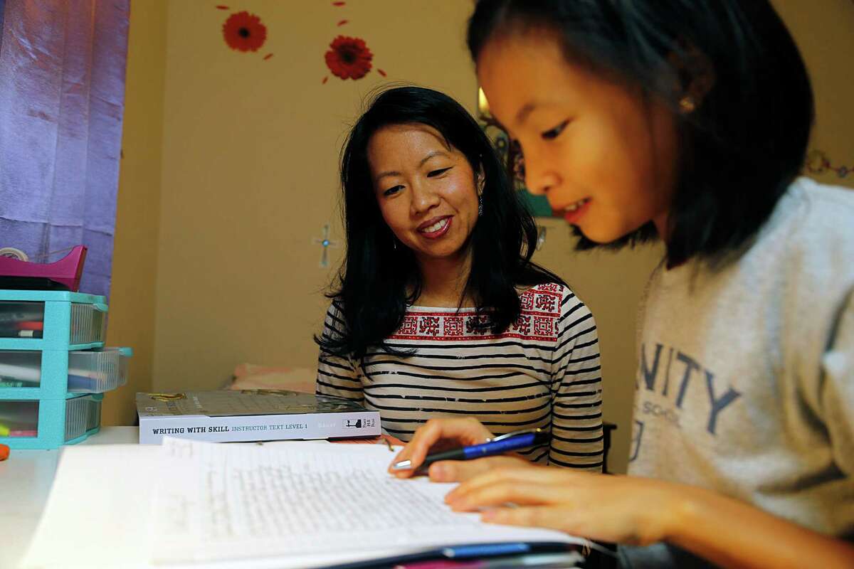 Cindy Wu home schools her children, including 10-year-old Alicia, in conjunction with Trinity Classical. during a home school lesson Thursday, Dec. 17, 2015, in Sugar Land. ( James Nielsen / Houston Chronicle )