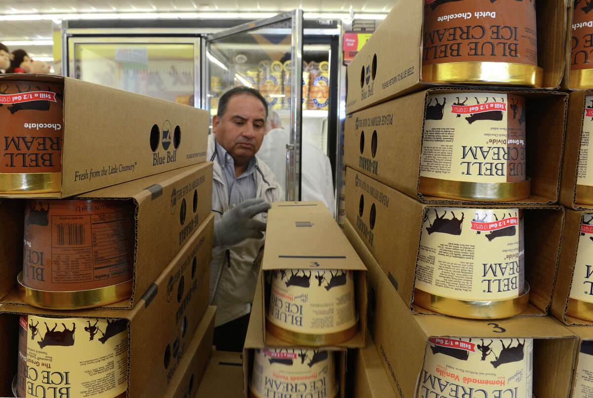 Robert Maldonado restocks Blue Bell containers last week at an Albertsons store in El Paso. Seven more Blue Bell flavors returned to grocery shelves Monday.
