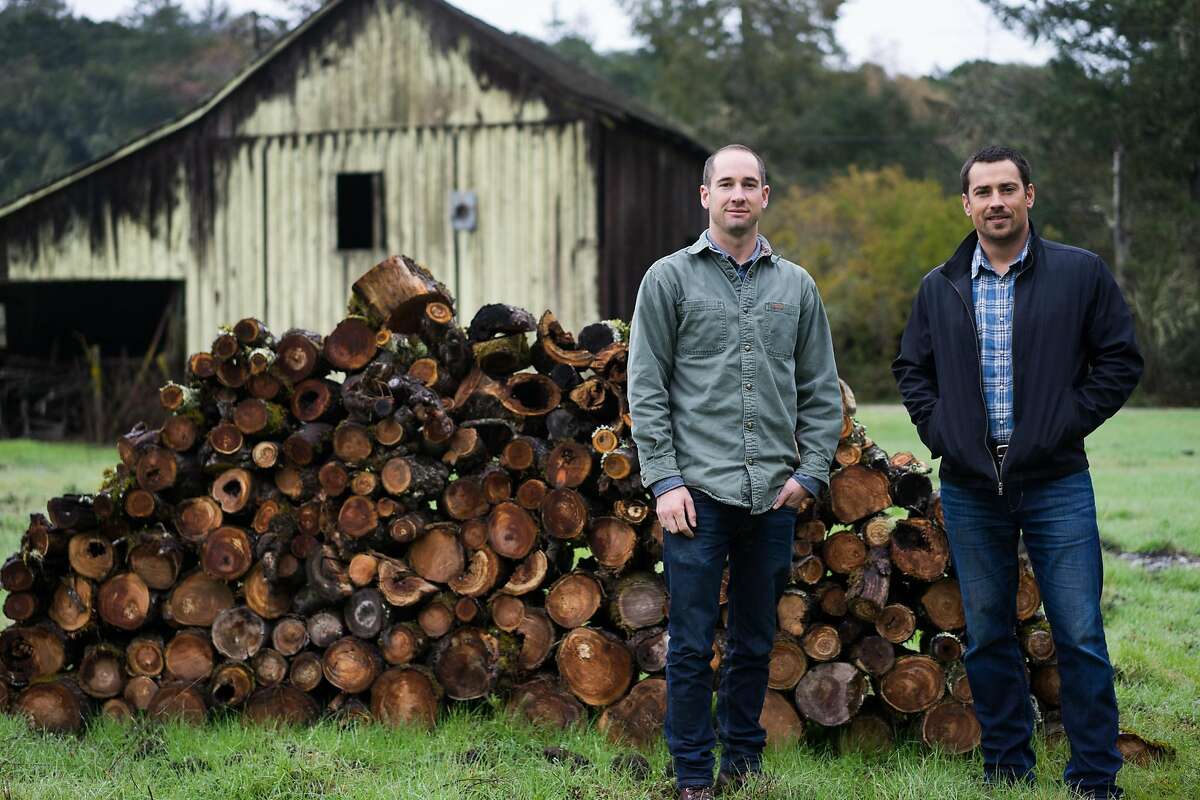 Mikey Giugni, left, and Michael Brughelli pose for a photo at Bear Valley Ranch in Aptos, Calif on Sunday, Dec. 20, 2015. Giugni and Brughelli are winemakers who are now making hard cider.