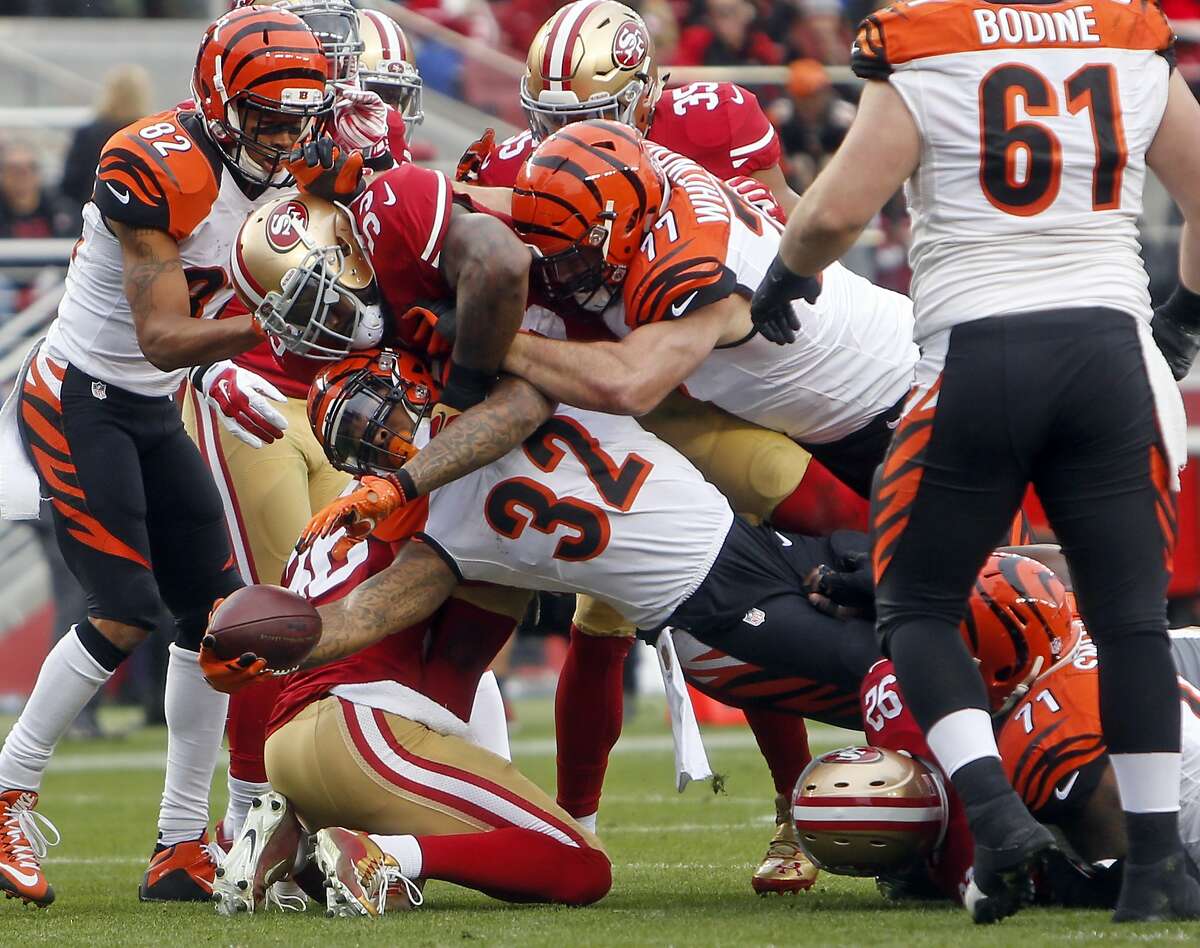 Cincinnati Bengals' Jeremy Hill reaches for the goal line while being tackled by San Francisco 49ers' NaVorro Bowman in 2nd quarter during NFL game in Santa Clara, Calif., on Sunday, December 20, 2015.