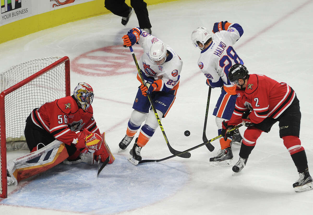 From left; Portland goalie Mike McKenna defends against Sound Tigers James Wright and Mike Halmo as Pirates defenseman Mackenzie Weegar tries to break up the play in the second period of their AHL hockey game at the Webster Bank Arena in Bridgeport, Conn. on Sunday, December 20, 2015.