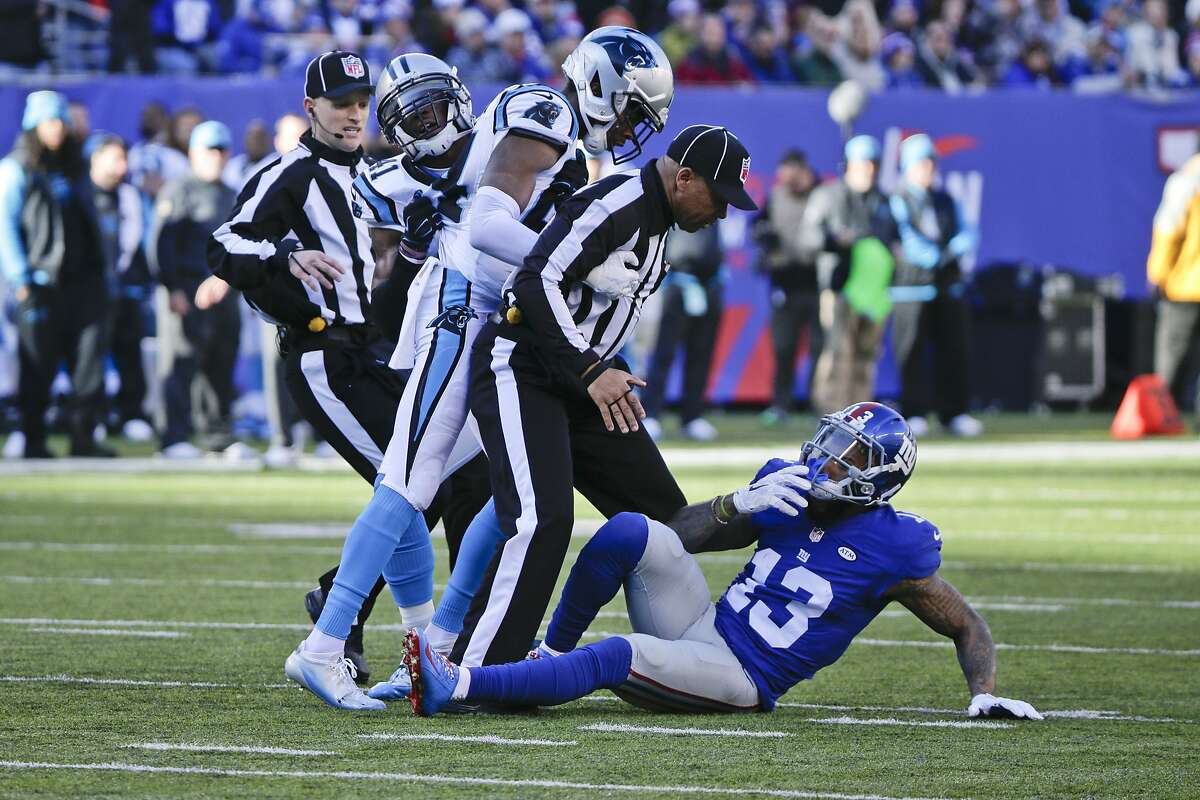 Side judge Michael Banks (72) separates Carolina Panthers' Josh Norman (24) and New York Giants' Odell Beckham (13) during the first half of an NFL football game Sunday, Dec. 20, 2015, in East Rutherford, N.J. (AP Photo/Julie Jacobson)