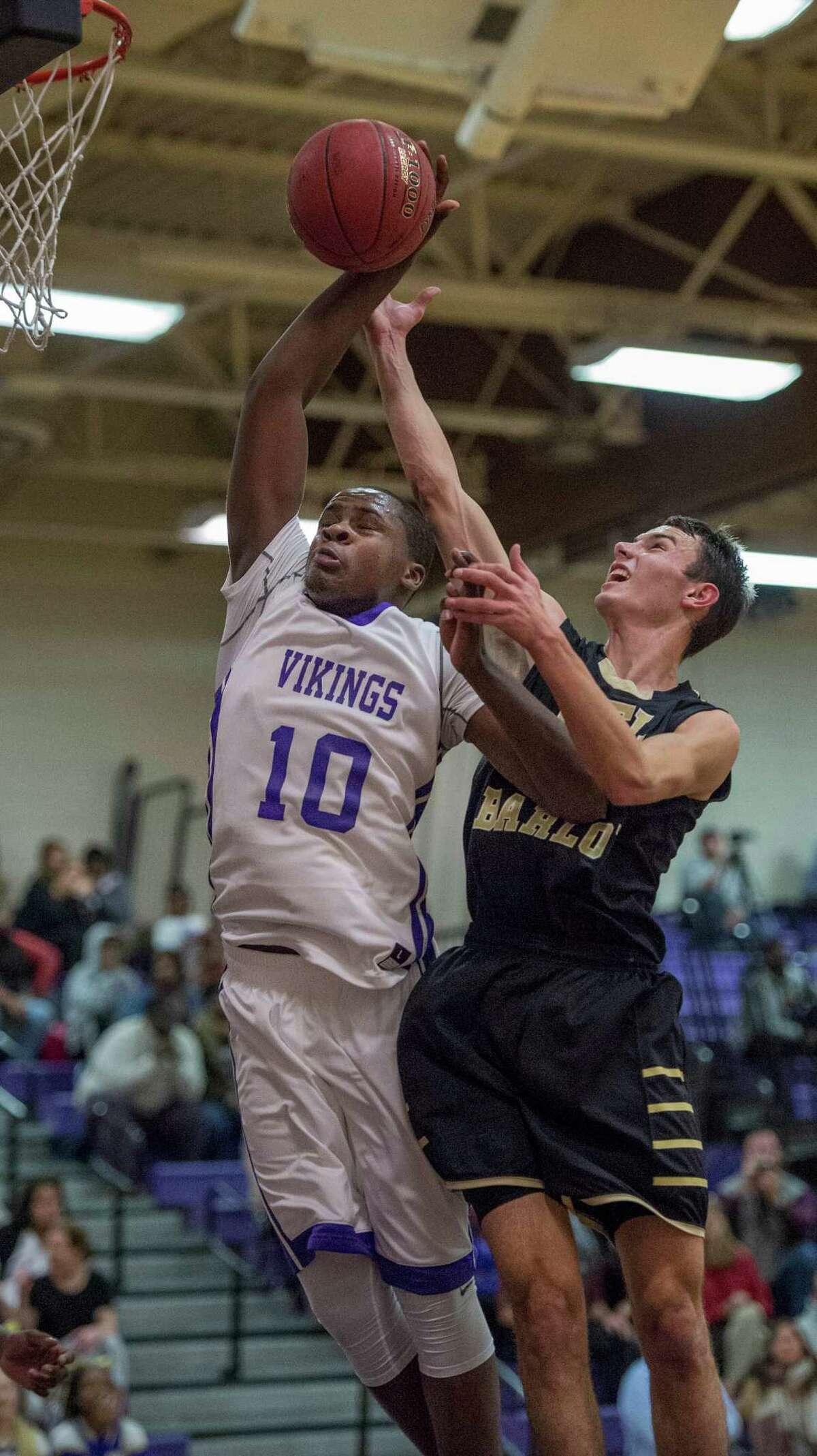Westhill’s Tyrell Alexander and Joel Barlow’s Ryan Corr battle for a rebound during a boys basketball game played at Westhill High School in Stamford on Monday night.