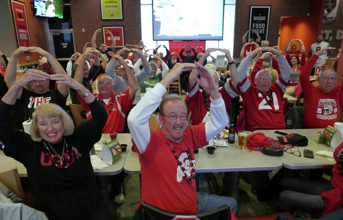 Members of the Ohio State University football fan club gather for their Kegs and Eggs breakfast before they watch the Ohio State versus Michigan football game at Buffalo Wings & Rings on Loop 1604 on Saturday, Nov. 28, 2015.