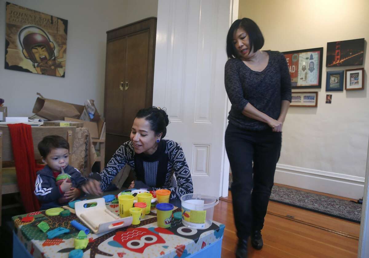 Nanny Zaira Medina (center) plays with 21-month-old Kingston Stillman as his mother Stephanie Ong Stillman prepares to leave for work in San Francisco, Calif. on Tuesday, Dec. 22, 2015. Ong Stillman had an impossible time finding daycare for Kingston just after he was born so Stillman turned to Medina for a shared nanny arrangement with another family.
