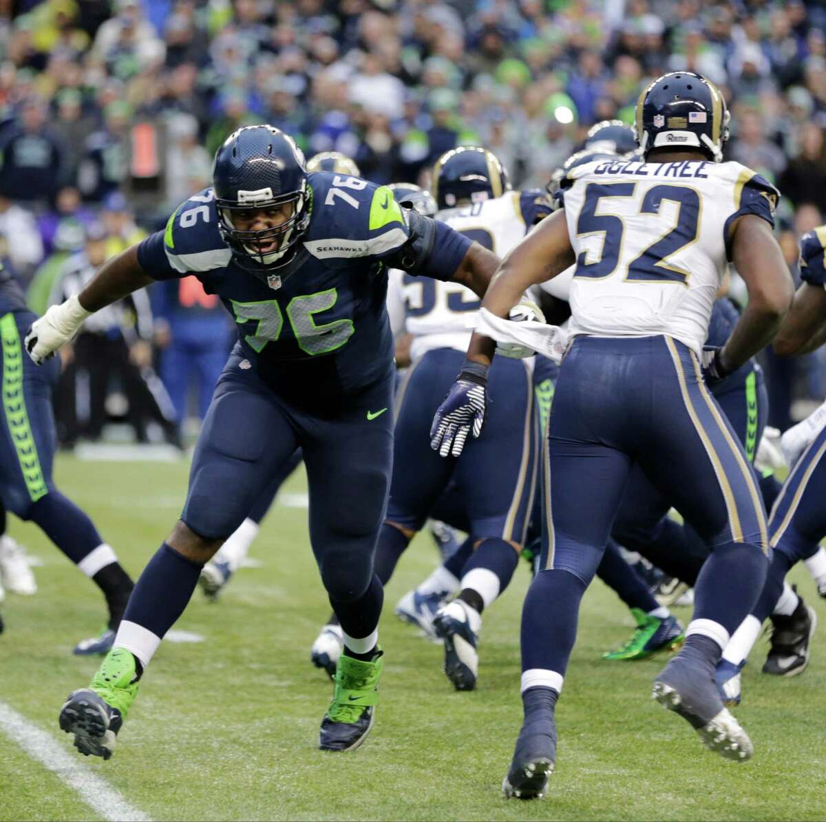 Seattle Seahawks offensive tackle Russell Okung squares off against St. Louis Rams linebacker Alec Ogletree in the second half of an NFL football game, Sunday, Dec. 28, 2014, in Seattle.