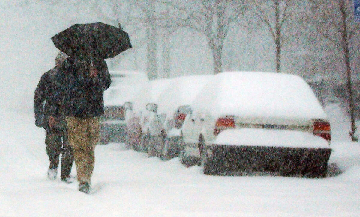 Pedestrians walk along State Street near the Capitol during a Christmas Day snowstorm on Dec. 25, 2002, in Albany, N.Y. (James Goolsby/Times Union archive)