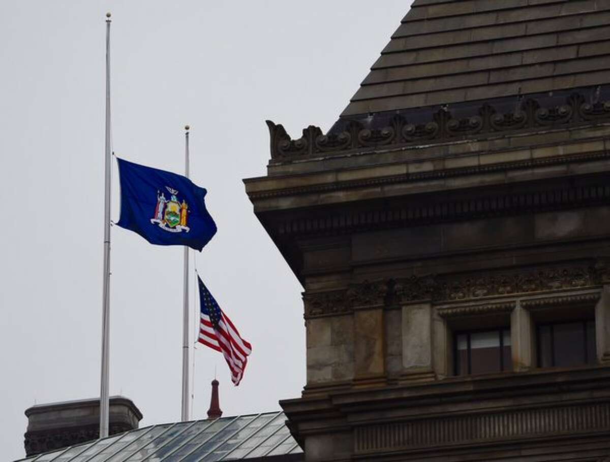Flags fly at half staff on state buildings on Wednesday, Dec. 23, 2015, to honor the state's fallen military service members. (Skip Dickstein/Times Union)