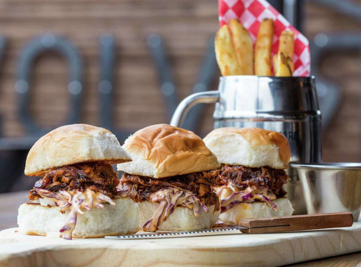 Revolver Bourbon Social has opened at 6502 Washington with an extensive menu of bourbon and whiskey, beer, wine and craft cocktails as well as a Texas-inflected American pub menu. Shown: Bourbon BBQ Pulled Pork Sliders w/Sriracha Cabbage.