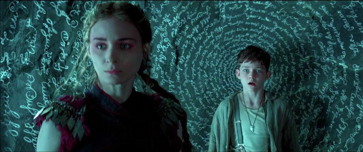 This photo provided by courtesy of Warner Bros. Pictures shows, Rooney Mara, left, as Tiger Lily, and Levi Miller as Peter, in a scene from the film, "Pan." The movie releases in U.S. theaters on Friday, Oct. 9, 2015. (Warner Bros. Pictures via AP) ORG XMIT: CAET421