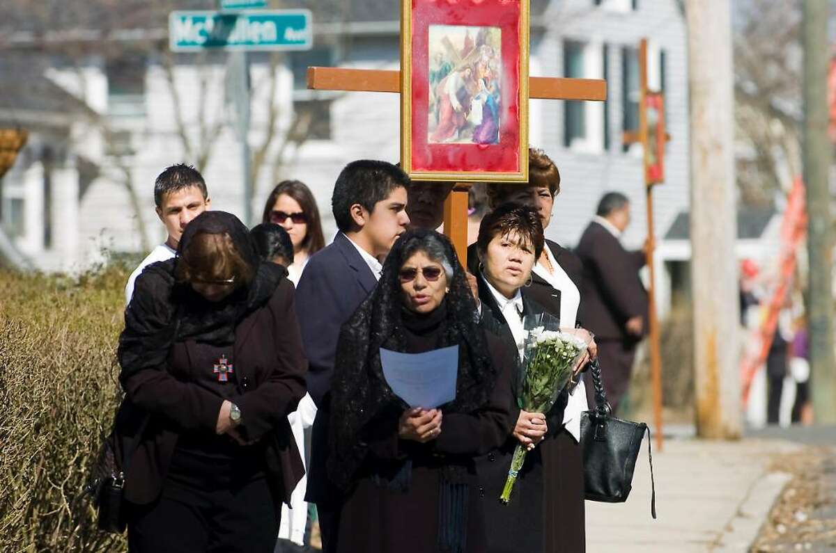 A group gathers at the sixth station as parishioners and residents participate in the Good Friday Stations of the Cross procession from Cummings Beach to Our Lady of Montserrat Church in Stamford, Conn. on Friday April 2, 2010