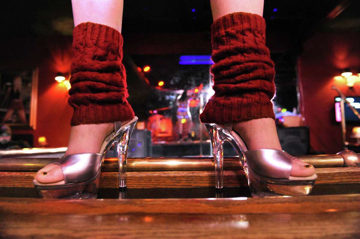 A dancer stands on the perimeter of the stage at Nite Moves on Monday, Nov. 23, 2015 in Latham, N.Y. (Lori Van Buren / Times Union)