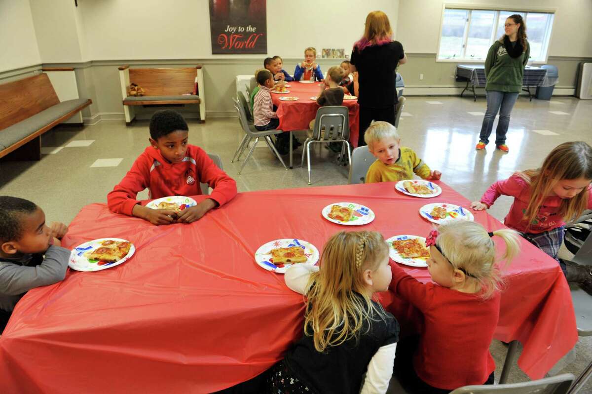 Children in the Home Schooling Co-Op take enjoy a pizza party at the Princetown Evangelical Presbyterian Church on Thursday, Dec. 17, 2015, in Duanesburg, N.Y. The students collected money to send to less fortunate children in Central America. (Paul Buckowski / Times Union)