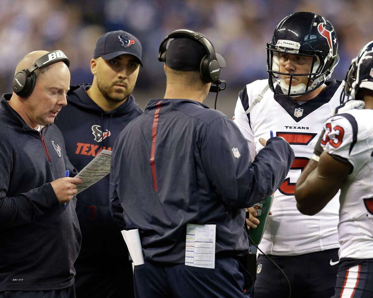 Texans offensive coordinator George Godsey and coach Bill O'Brien (in headsets) try to figure out plays that new backup quarterback Brandon Weeden (5) can run during a timeout at Indianapolis on Sunday.