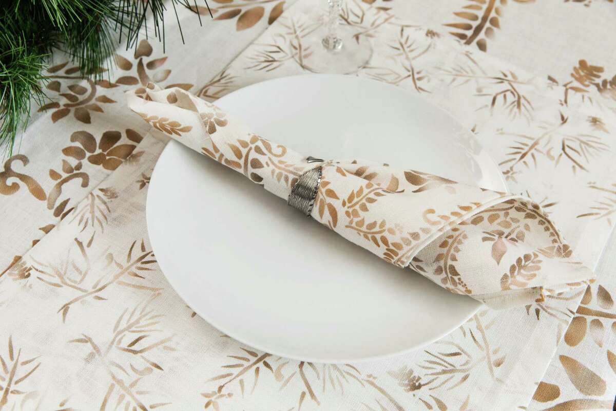 "Ember" dinner napkins ($160 for four), placemats ($165 for four) and table runner ($150), designed by Laura Umansky