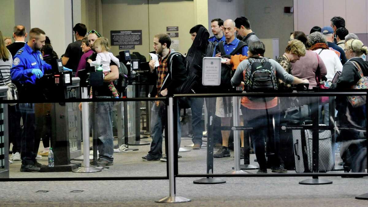 Travelers make their way through the security checkpoint before flying out at the Albany International Airport on Thursday, Dec. 24, 2015, in Colonie, N.Y. (Paul Buckowski / Times Union)