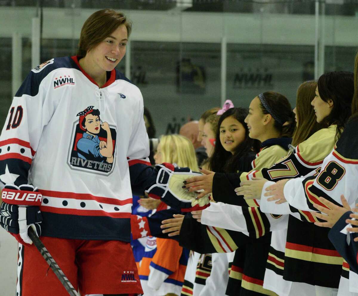 Ashley Johnston, a Union College graduate and Albany resident, plays with the New York Riveters. The Riveters, basedin Brooklyn, N.Y., are part of the new National Women's Hockey League. Here, Johnston meets with young fans. (Photo courtesy of Troy Parla)