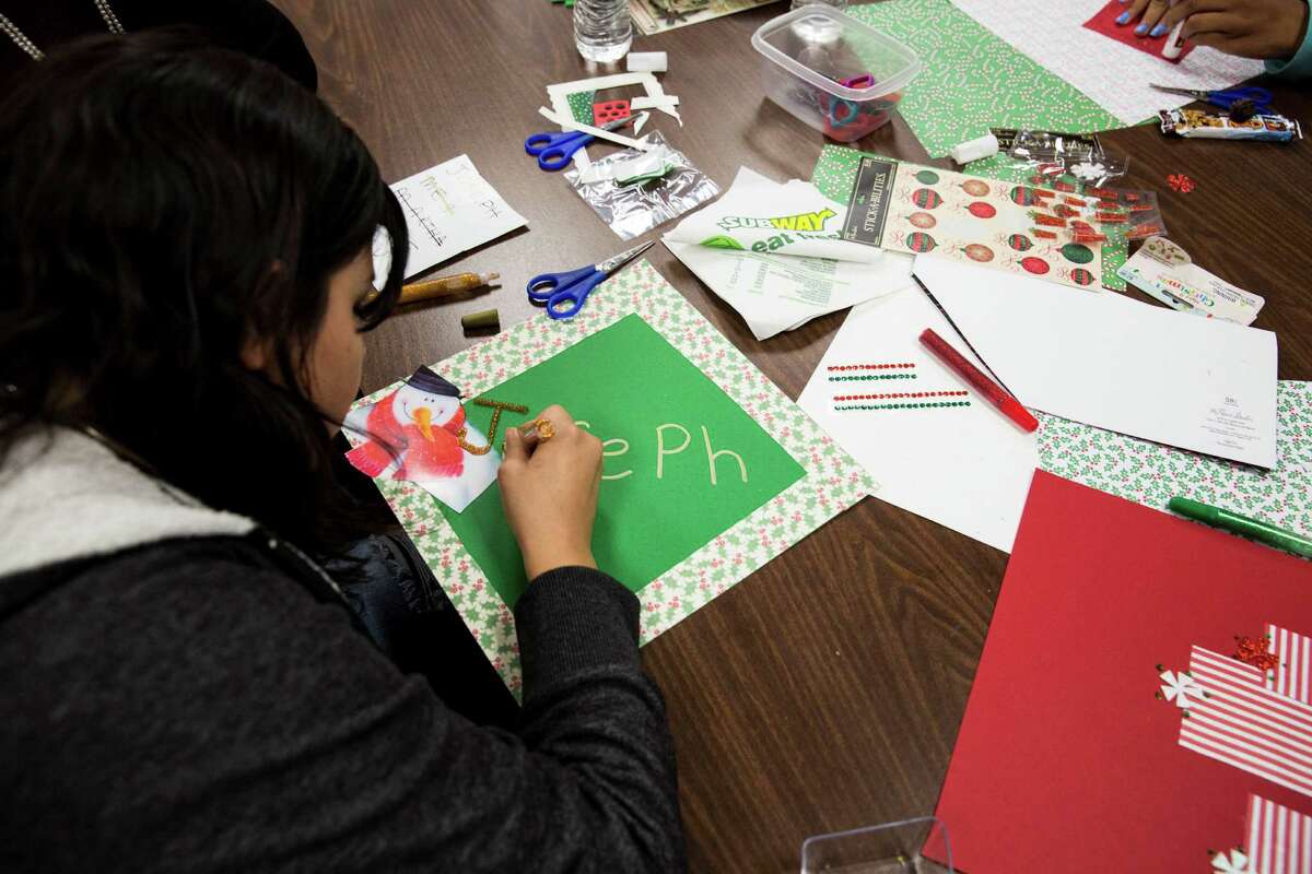 A girl works on a placemat for a resident of the Brookdale Hollywood Park Assisted Living Center during the PEARLS program Dec. 3. As a foster child, she is part of the program to give support and positive direction for girls to stay on the right path and out of the legal system.