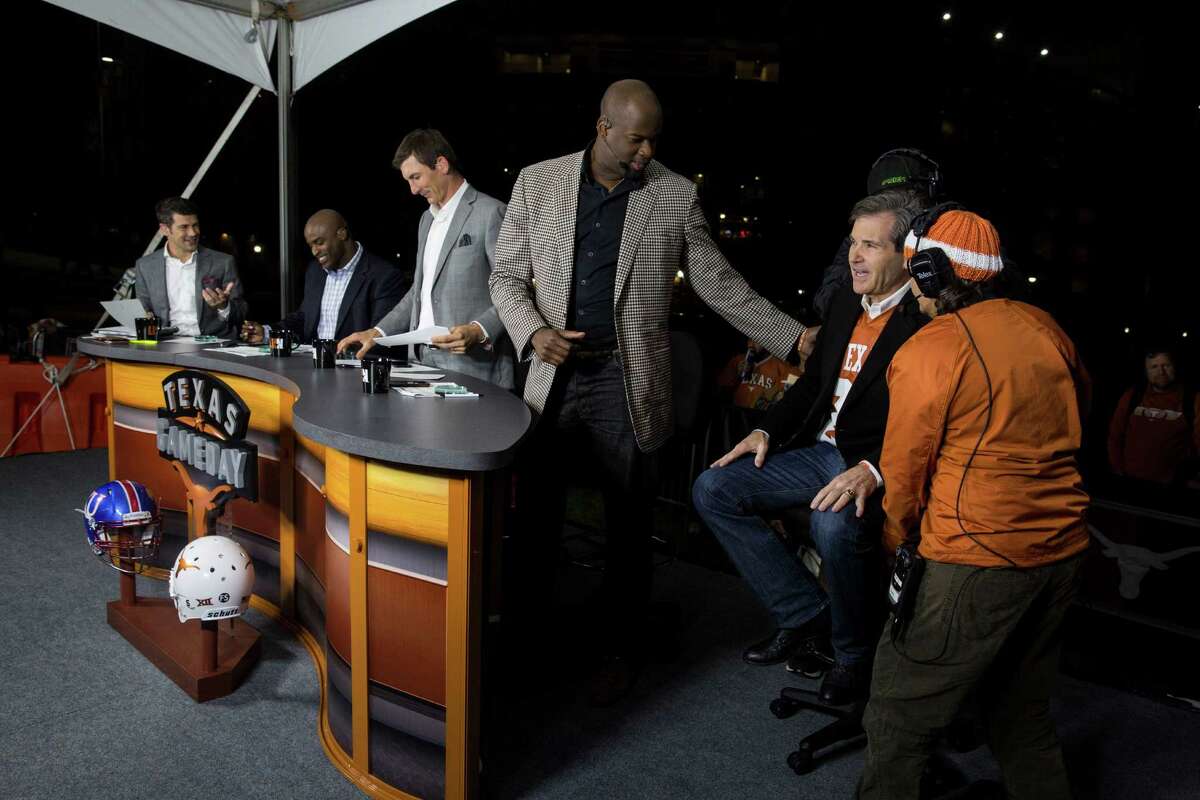 Shelly Lemkowitz, far right, gets guest Bobby Mitchell in place next to announcer Vince Young for filming during the Longhorn Network "Game Day" production before the football game against the University of Kansas at the University of Texas at Austin campus in Austin, Texas on November 7, 2015.