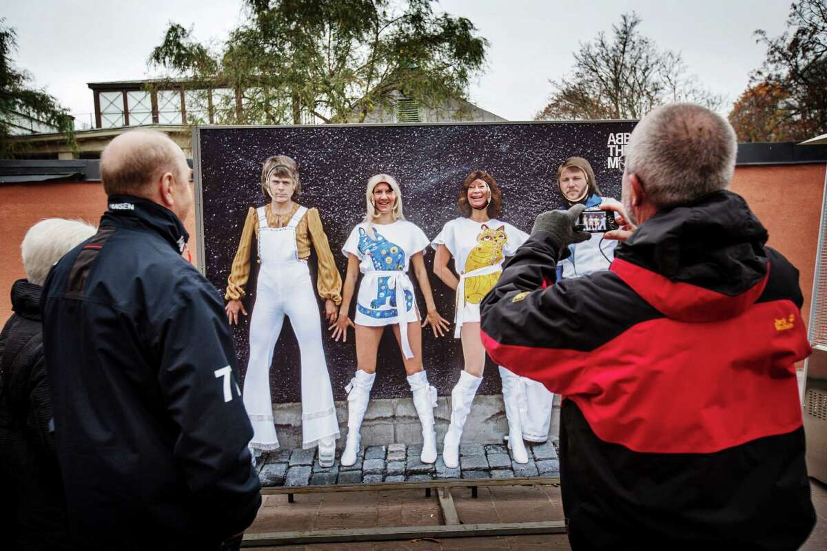 Visitors pause for a photo opportunity at the cashless Abba Museum in Stockholm﻿ in November. Few places are tilting toward a cashless future as quickly as Sweden, which has become hooked on the convenience of paying by plastic and mobile apps. ﻿