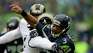 Seattle Seahawks quarterback Russell Wilson (3) is hit by St. Louis Rams' Mark Barron in the first half of an NFL football game, Sunday, Dec. 27, 2015, in Seattle. (AP Photo/John Froschauer)