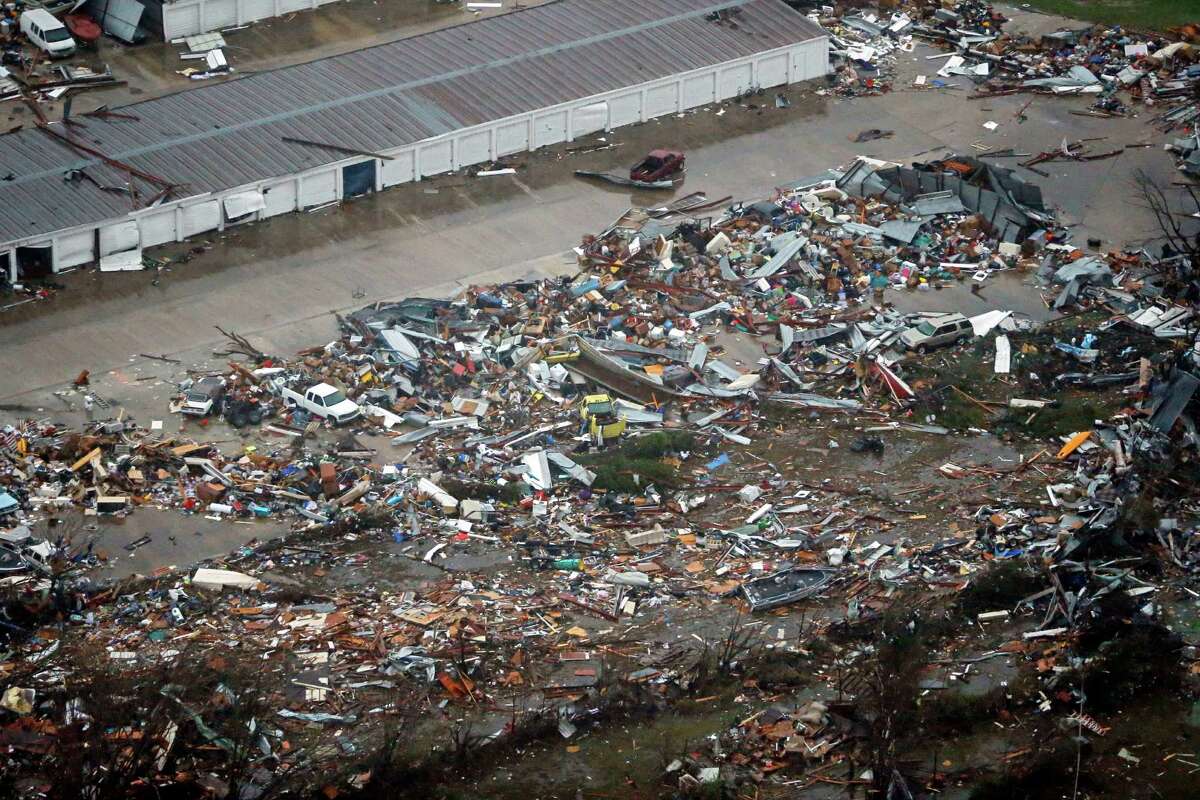 The remains of storage after Saturday's tornado spread out in Garland, Texas, Sunday, Dec. 27, 2015. At least 11 people died and dozens were injured in apparently strong tornadoes that swept through the Dallas area and caused substantial damage this weekend. (G.J. McCarthy/The Dallas Morning News via AP) MANDATORY CREDIT