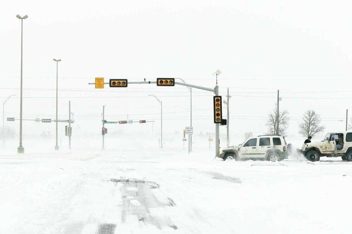 Drivers experience near white out conditions on December 27, 2015 in Lubbock, Texas. Coming on the heels of several strong tornadoes, some northern parts of Texas are experiencing blizzard conditions with wind gusts up to 50 mph and as much as 13 inches of snow forecast.