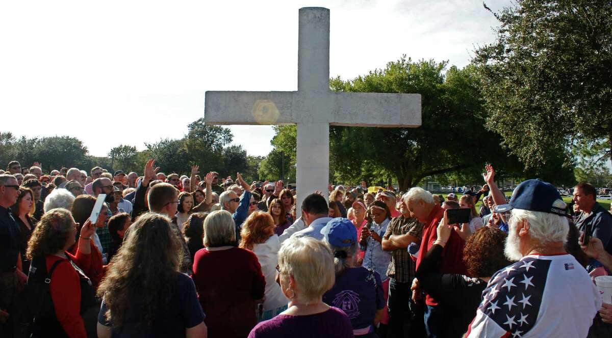 RELIGIOUS CONTROVERSY: Dozens rallied at Port Neches' Riverfront Park on Nov. 15 after a group called the Freedom from Religion Foundation asked the city to take down a 45-year-old permanent cross display because it violates the "principle of separation between church and state." Photo taken Sunday, November 15, 2015 Michelle Heath/The Enterprise
