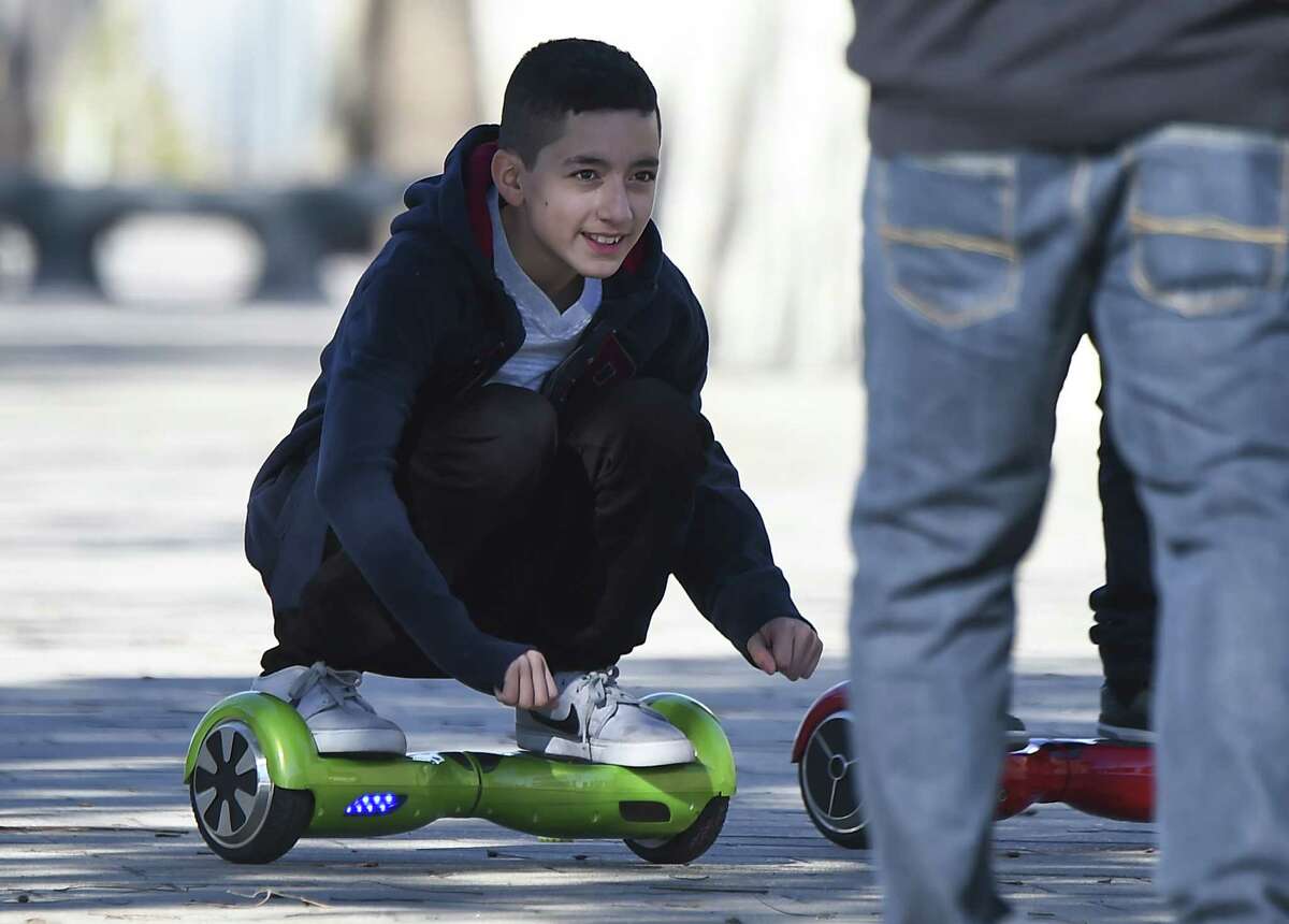 A boy rides a hoverboard the day after Christmas, in San Pedro, California December 26, 2015. Reports of some hoverboards, also known as self-balancing, two-wheeled scooters catching fire have led to an investigation by the Consumer Product Safety Commission. AFP PHOTO / ROBYN BECKROBYN BECK/AFP/Getty Images