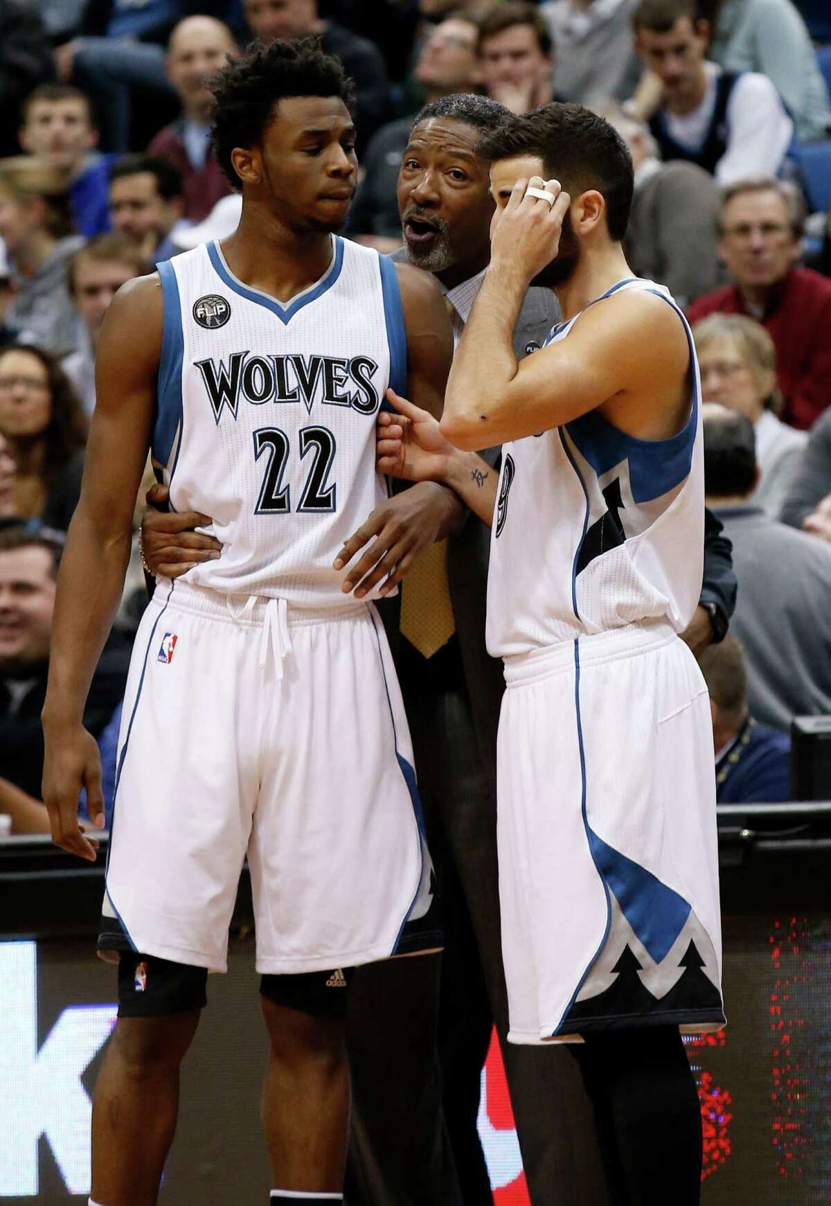 Minnesota Timberwolves head coach Sam Mitchell, center, talks with guards Andrew Wiggins (22) and Ricky Rubio, right, during the first half of an NBA basketball game against the Indiana Pacers in Minneapolis, Saturday, Dec. 26, 2015. (AP Photo/Ann Heisenfelt)