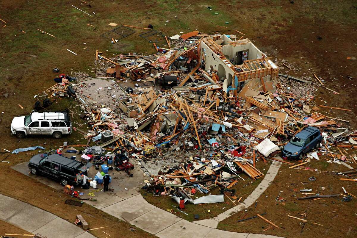 This aerial photo shows a damaged home after a tornado ripped through the area Monday, Dec. 28, 2015, in Red Oak, Texas. Residents surveyed the destruction from deadly tornadoes in North Texas as the same storm system brought winter woes to the Midwest on Monday, amplifying flooding that's blamed for more than a dozen deaths and prompting hundreds of flight cancellations. (G.J. McCarthy/The Dallas Morning News via AP) MANDATORY CREDIT; MAGS OUT; TV OUT; INTERNET USE BY AP MEMBERS ONLY;