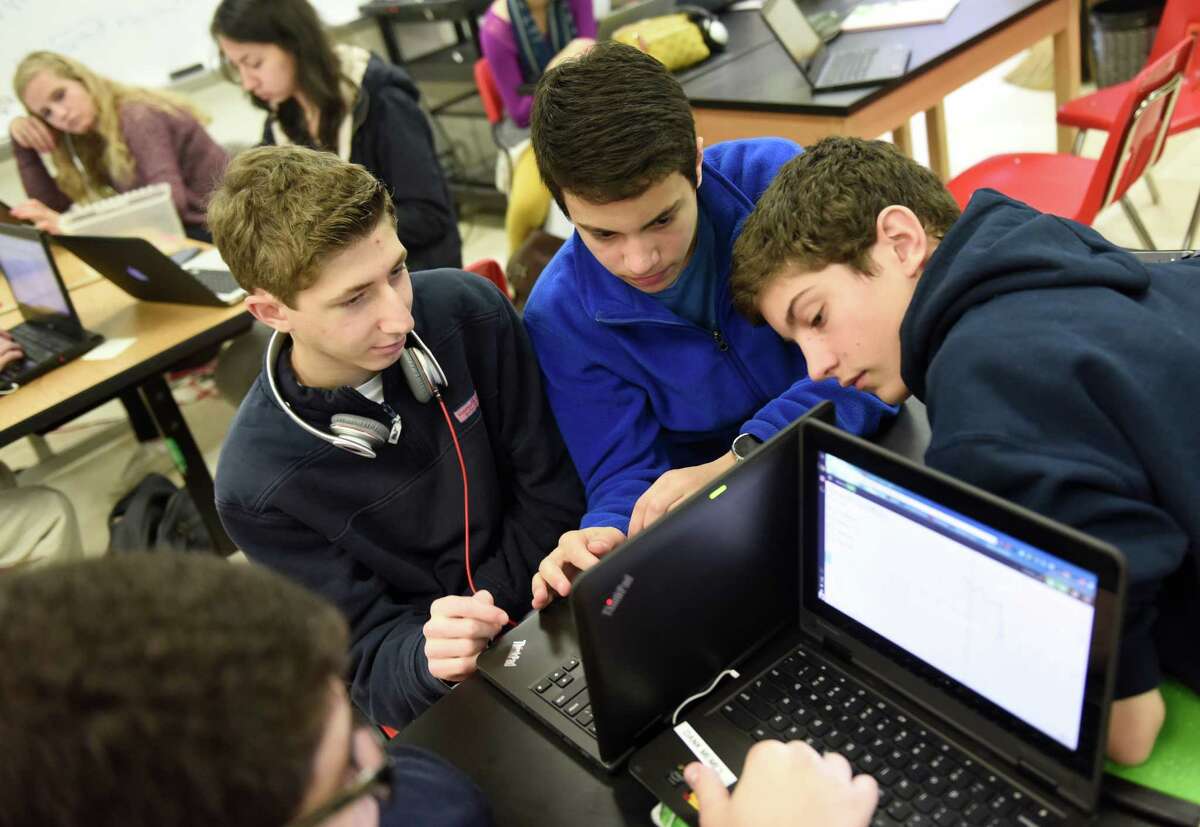 GHS sophomores Grant Cooper, left, Rich Consiglio, center, and Owen White work on a project in the Innovation Lab at Greenwich High School in Greenwich. Innovation Lab students are working on an artistic graphing project in which they come up with a design and write equations to plot the lines on a graph using a Chromebook computer program.